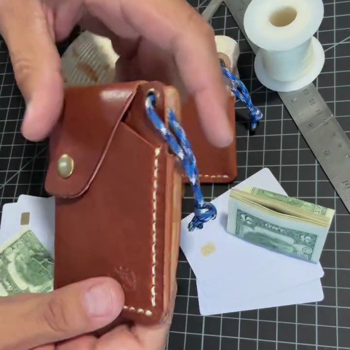 A High Tide wallet held at the bench, flap closed