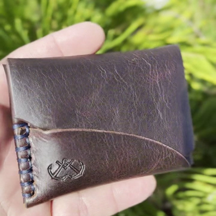 Front of the wallet held outdoors