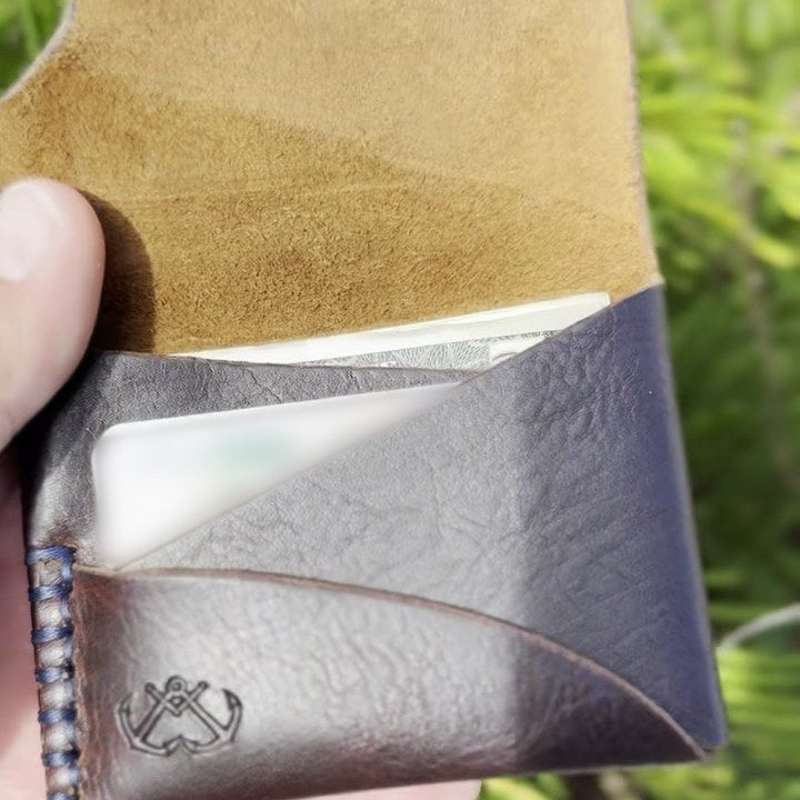 The wallet open with a card and folded cash