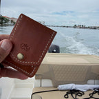 The Skipper held up on a boat with the water behind it